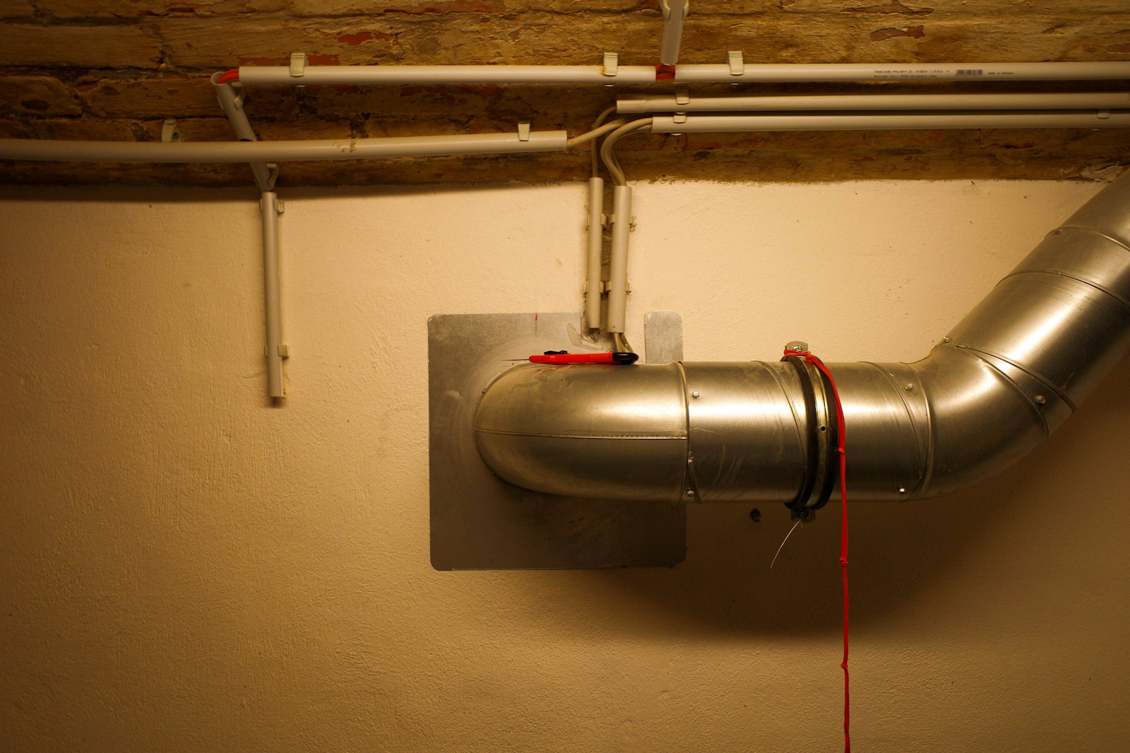 A metal pipe is attached to a wall