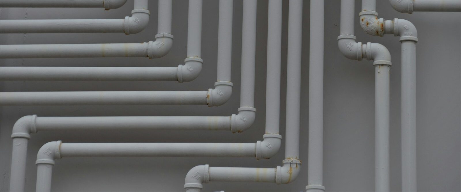 a close up of a bunch of pipes on a wall